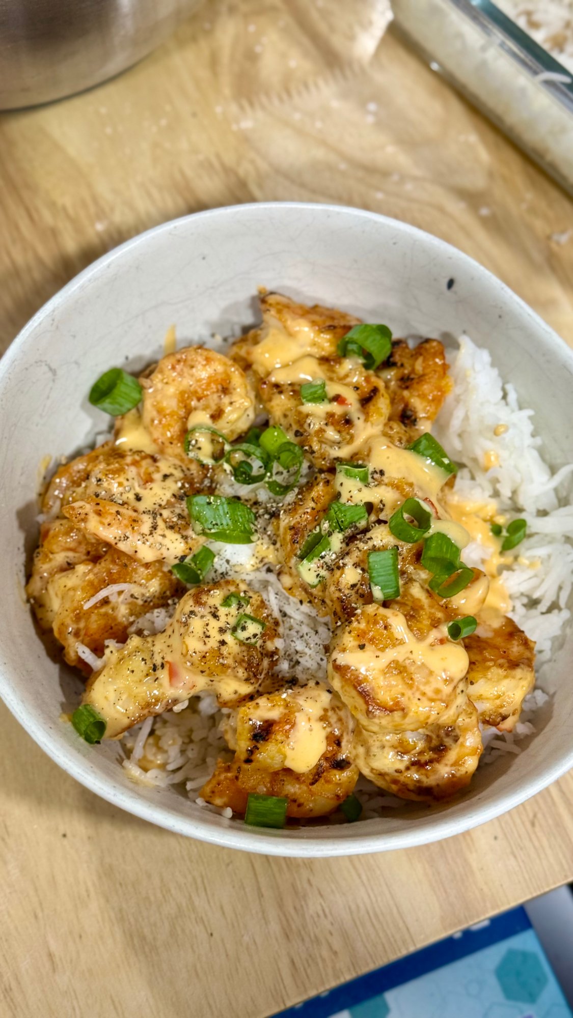Bada Bing shrimp over basmati rice, drizzled with creamy sweet-hot sauce and finished with sliced green onions.